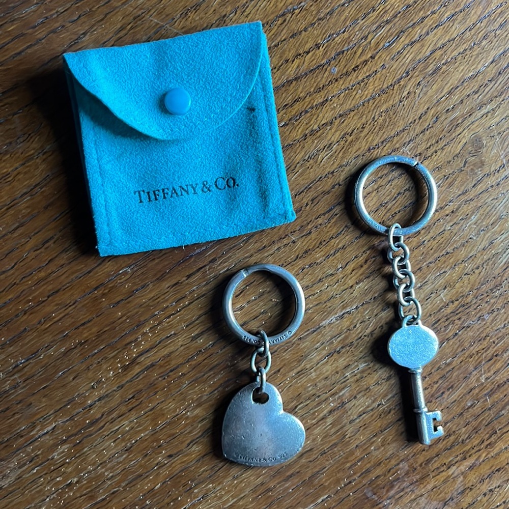 Two Tiffany and Co. silver key chains with dust bag